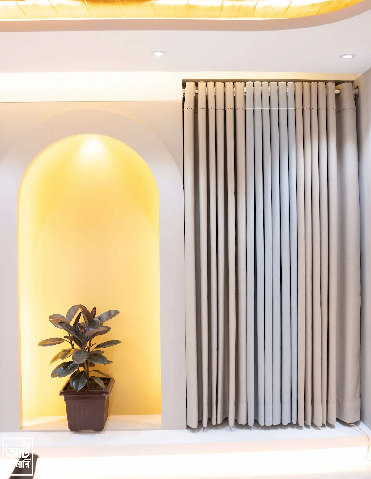 Modern grey curtain display with warm arched lighting at Curtivelle showroom