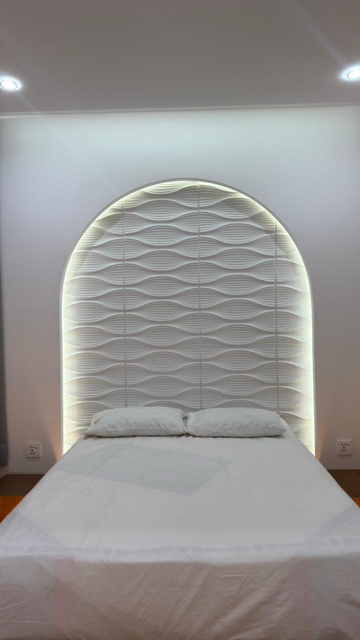 Bedroom curtain design with elegant drapes and upholstered headboard by Curtivelle