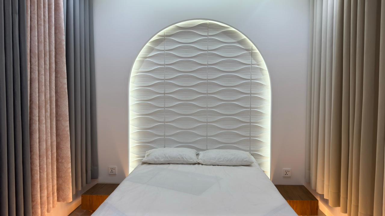 Bedroom curtain design with elegant drapes and upholstered headboard by Curtivelle