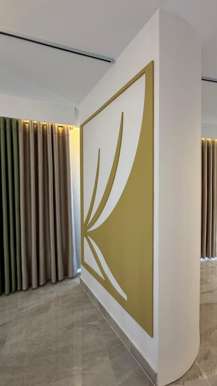 Curtivelle branded showroom wall with premium curtain displays