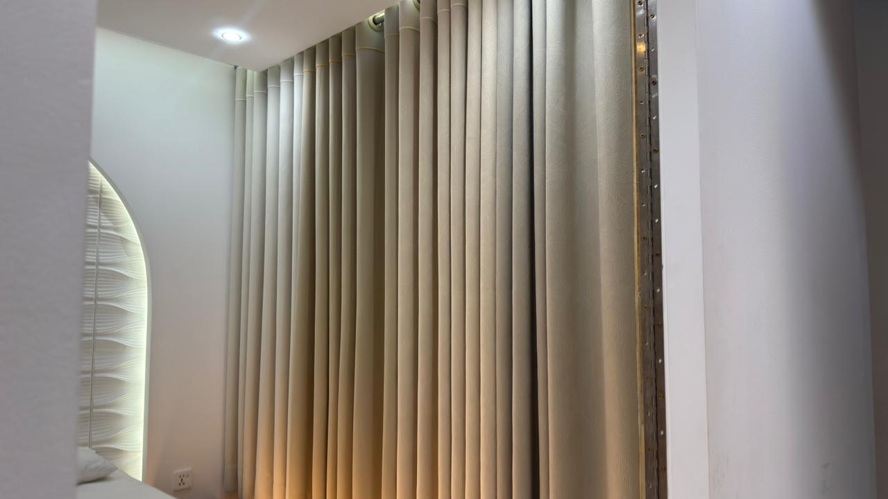 Curtivelle branded showroom wall with premium curtain displays