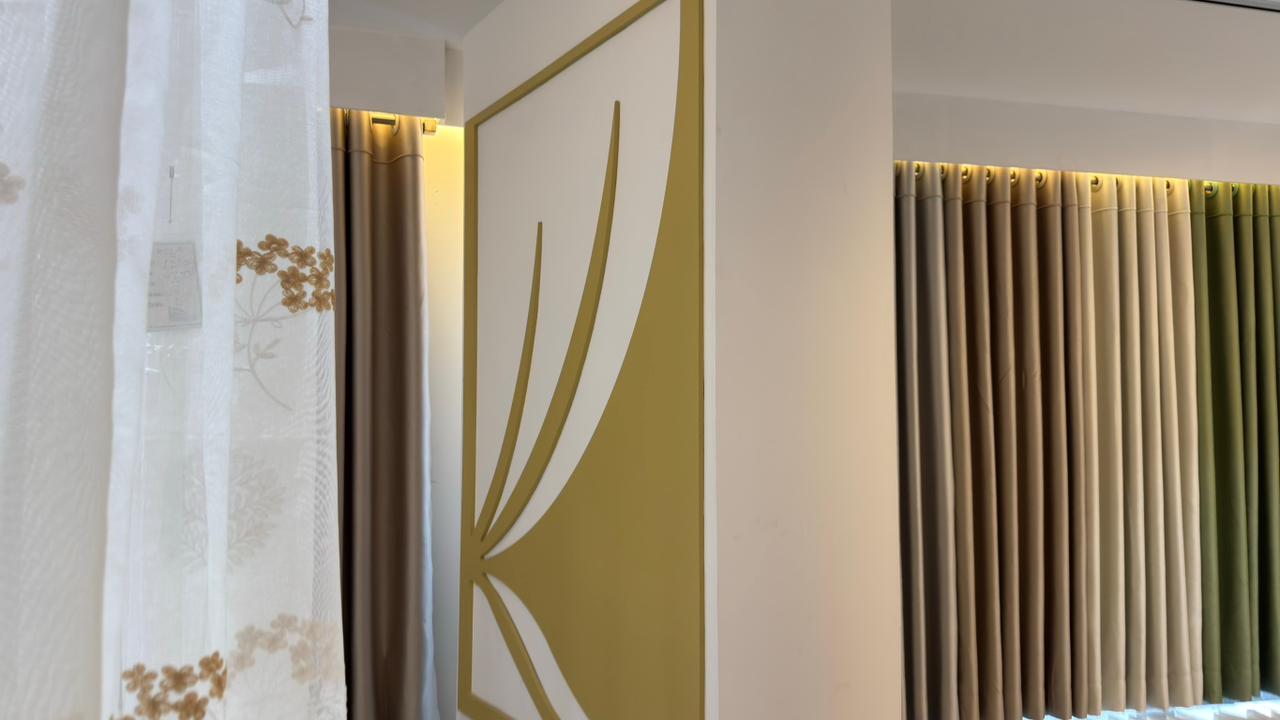Curtivelle branded showroom wall with premium curtain displays