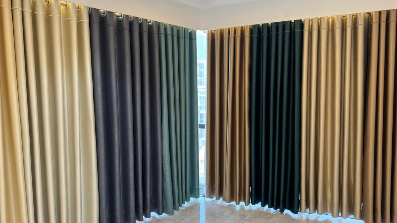 Luxury curtain showroom display with colored fabric panels and modern lighting