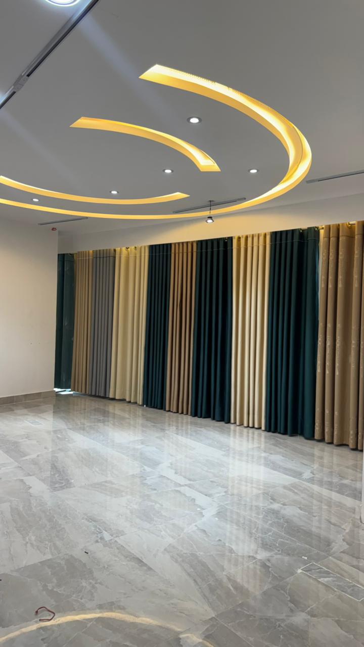 Luxury curtain showroom display with colored fabric panels and modern lighting
