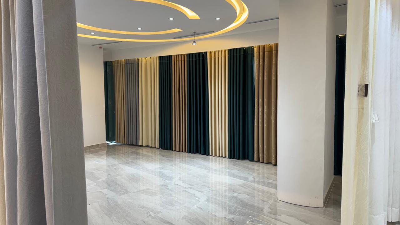 Luxury curtain showroom display with colored fabric panels and modern lighting