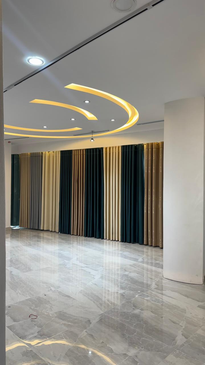 Luxury curtain showroom display with colored fabric panels and modern lighting