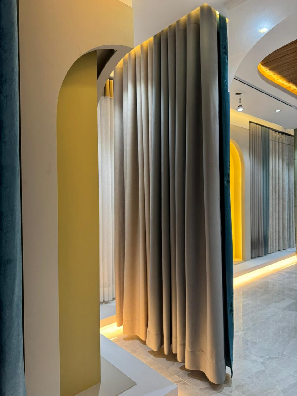 Curtivelle showroom curtain display with grey, blue and floral drapes