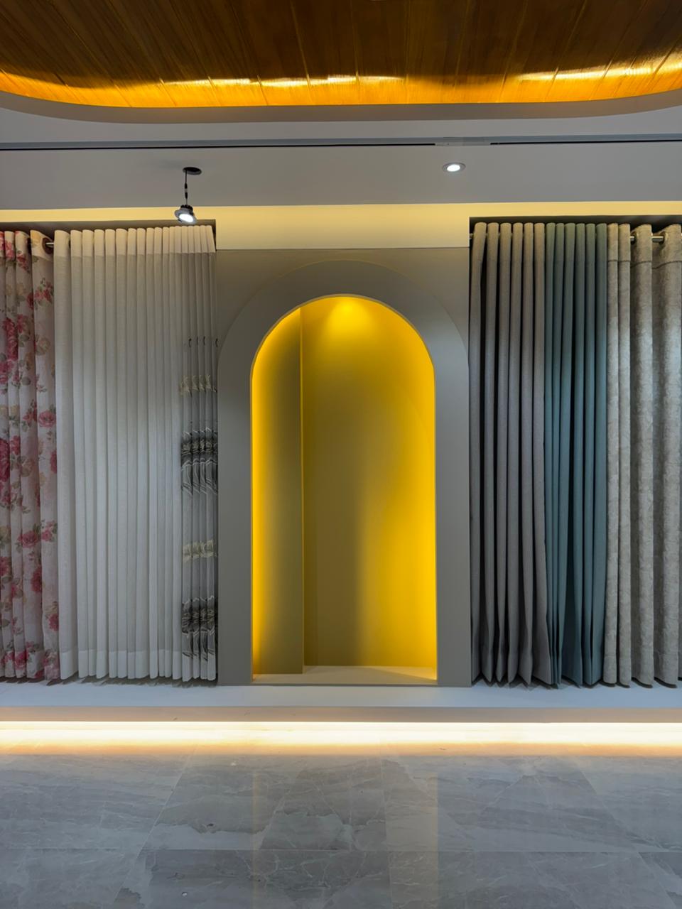 Curtivelle showroom curtain display with grey, blue and floral drapes