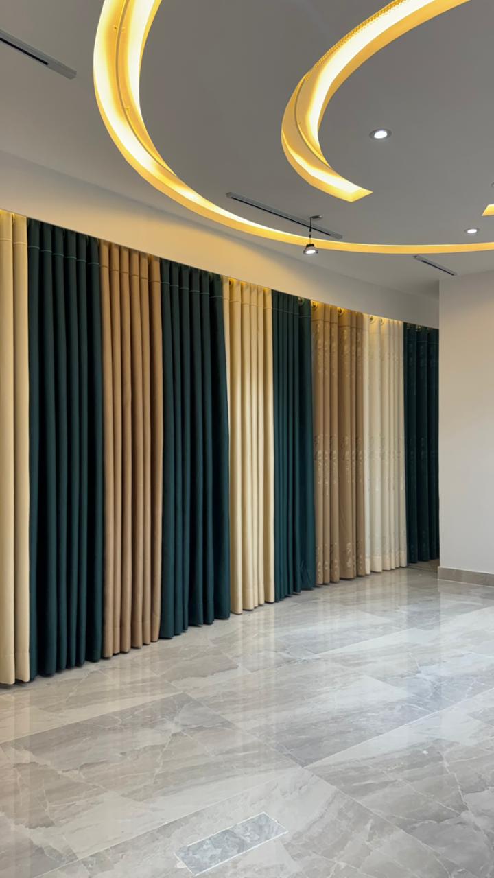 Curtivelle showroom window curtain installation with grey and blue drapes