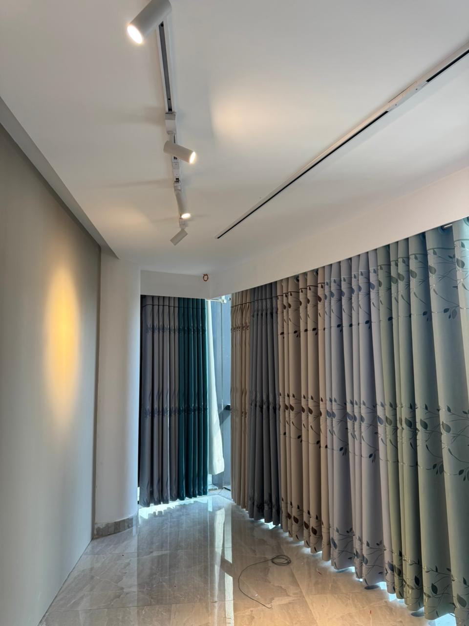 Modern curtain showroom interior with premium fabric panels and arched lighting