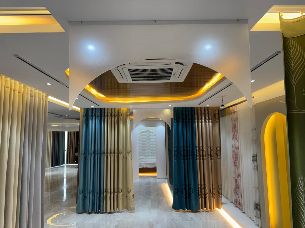 Modern curtain showroom interior with premium fabric panels and arched lighting