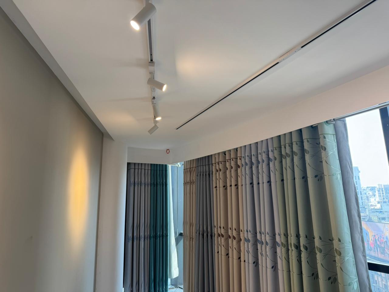 Modern curtain showroom interior with premium fabric panels and arched lighting