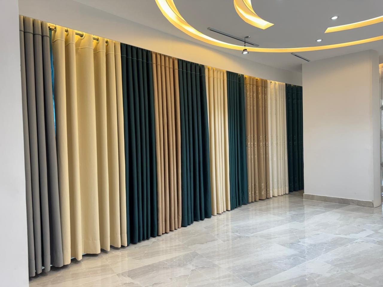 Modern curtain showroom interior with premium fabric panels and arched lighting