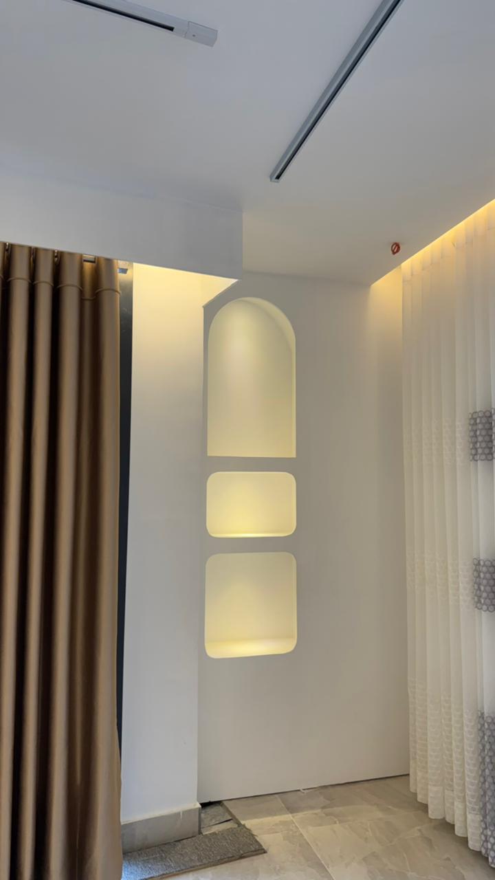 Modern curtain showroom interior with premium fabric panels and arched lighting