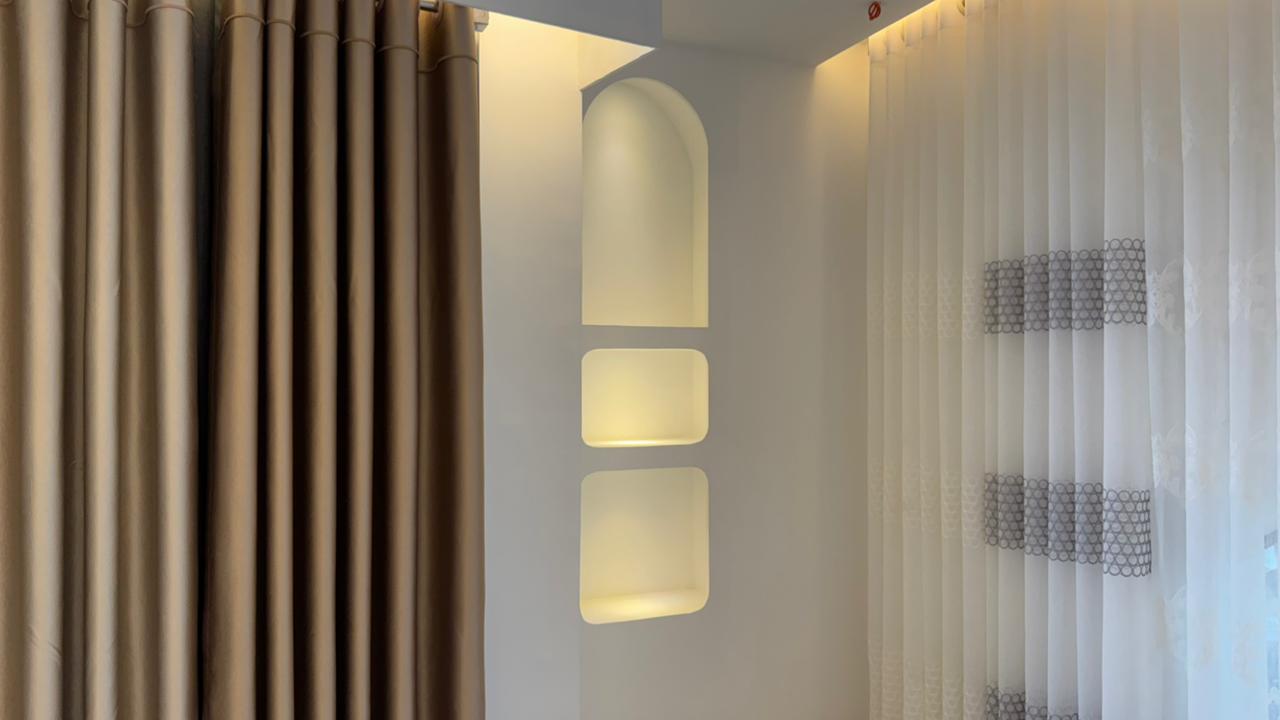 Modern curtain showroom interior with premium fabric panels and arched lighting