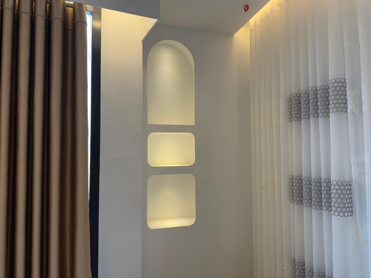 Modern curtain showroom interior with premium fabric panels and arched lighting