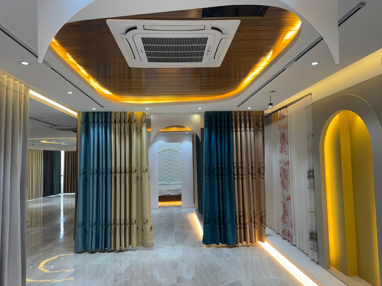 Premium curtain showroom interior with layered drapes and warm lighting