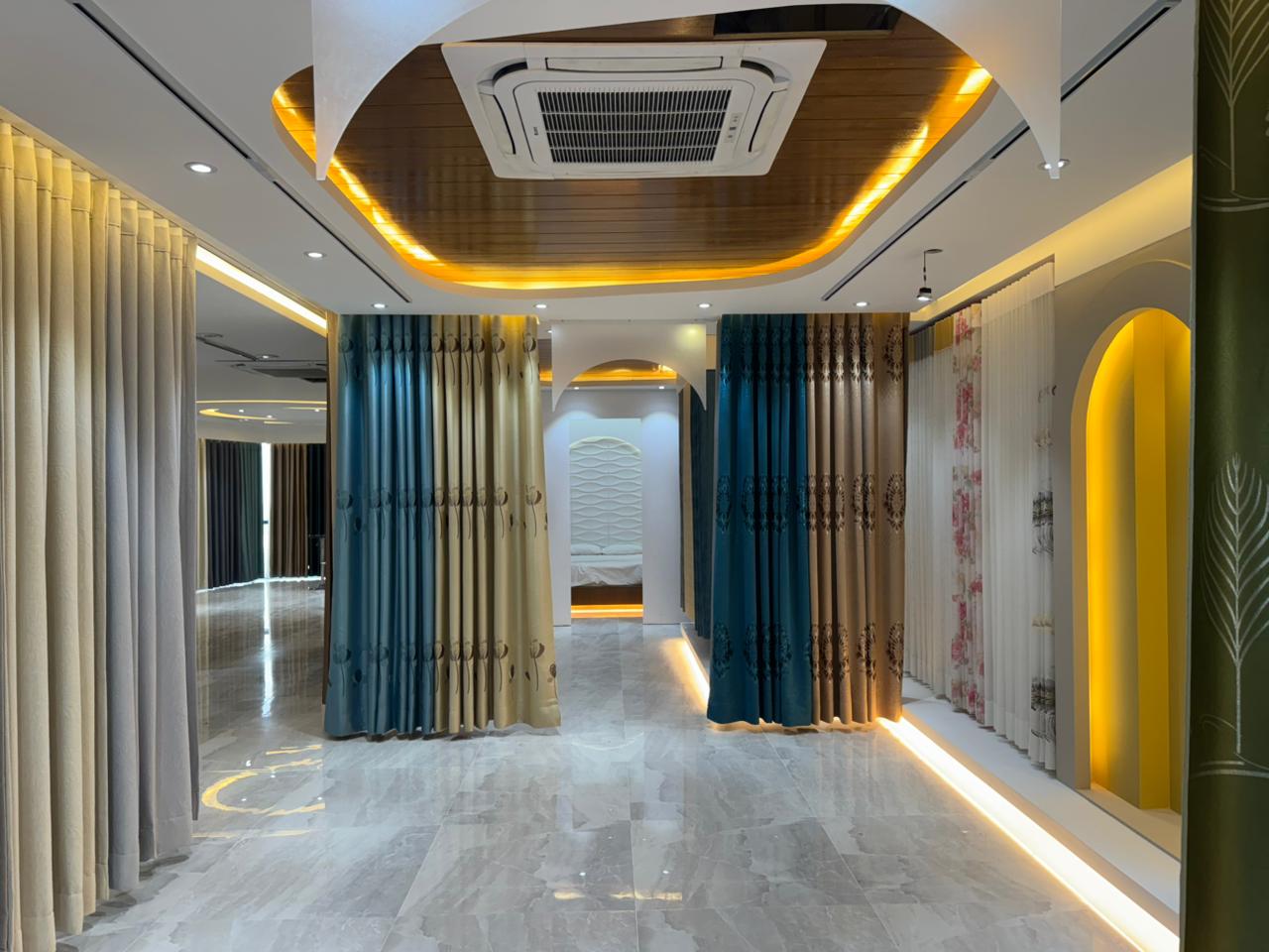 Premium curtain showroom interior with layered drapes and warm lighting
