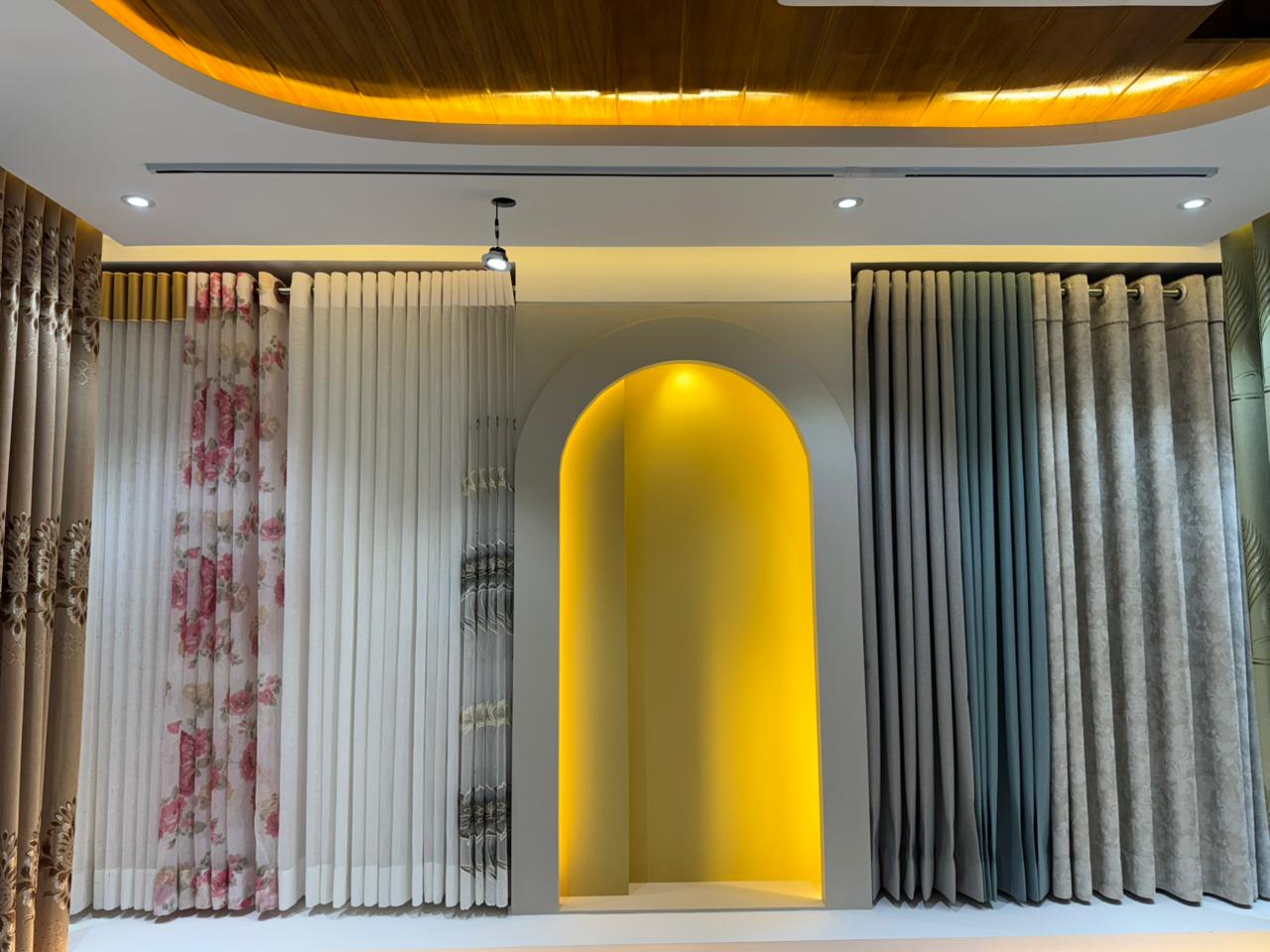 Premium curtain showroom interior with layered drapes and warm lighting