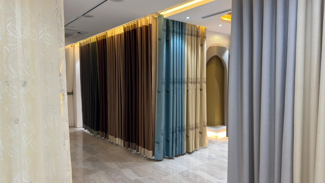 Close-up of premium pleated curtain fabrics in Curtivelle showroom