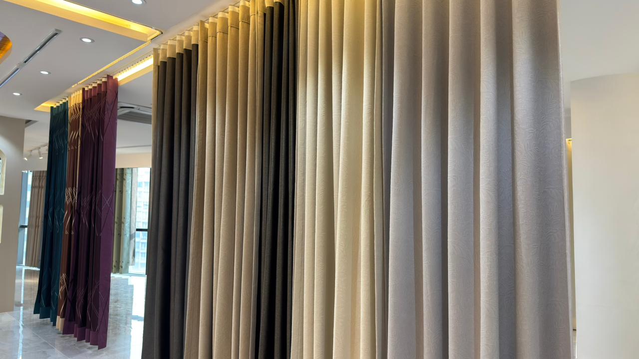 Close-up of premium pleated curtain fabrics in Curtivelle showroom