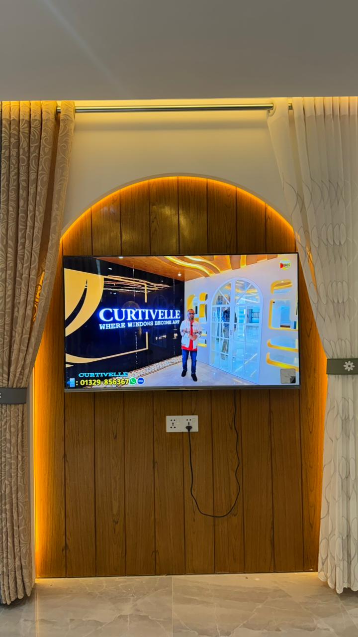 Curtivelle showroom media wall with sheer and blackout curtain displays