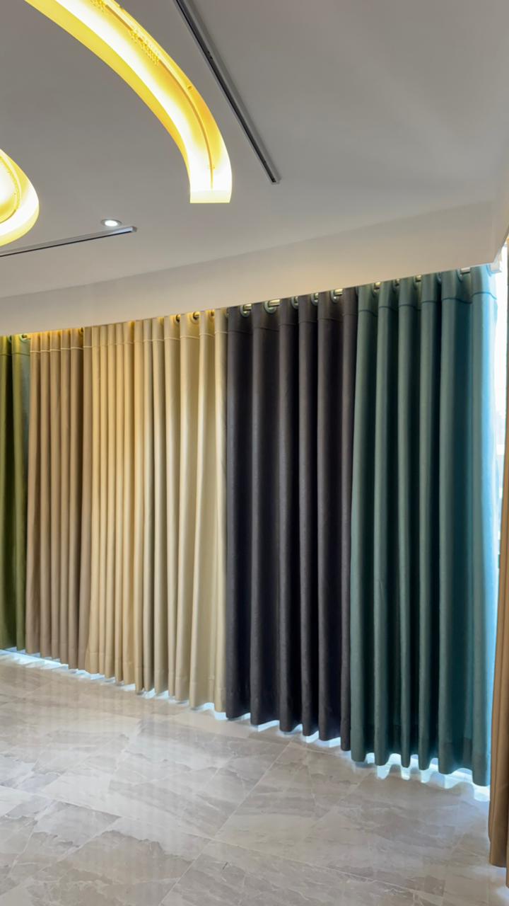 Curtivelle showroom media wall with sheer and blackout curtain displays