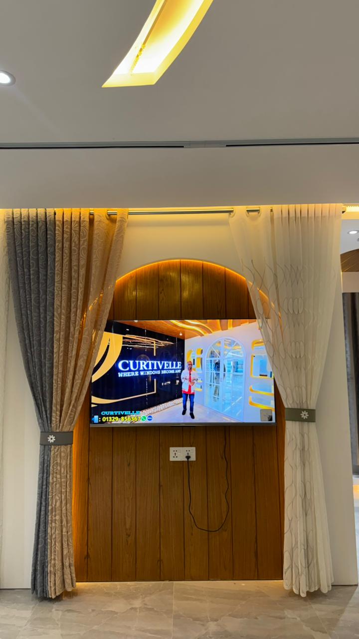 Curtivelle showroom media wall with sheer and blackout curtain displays
