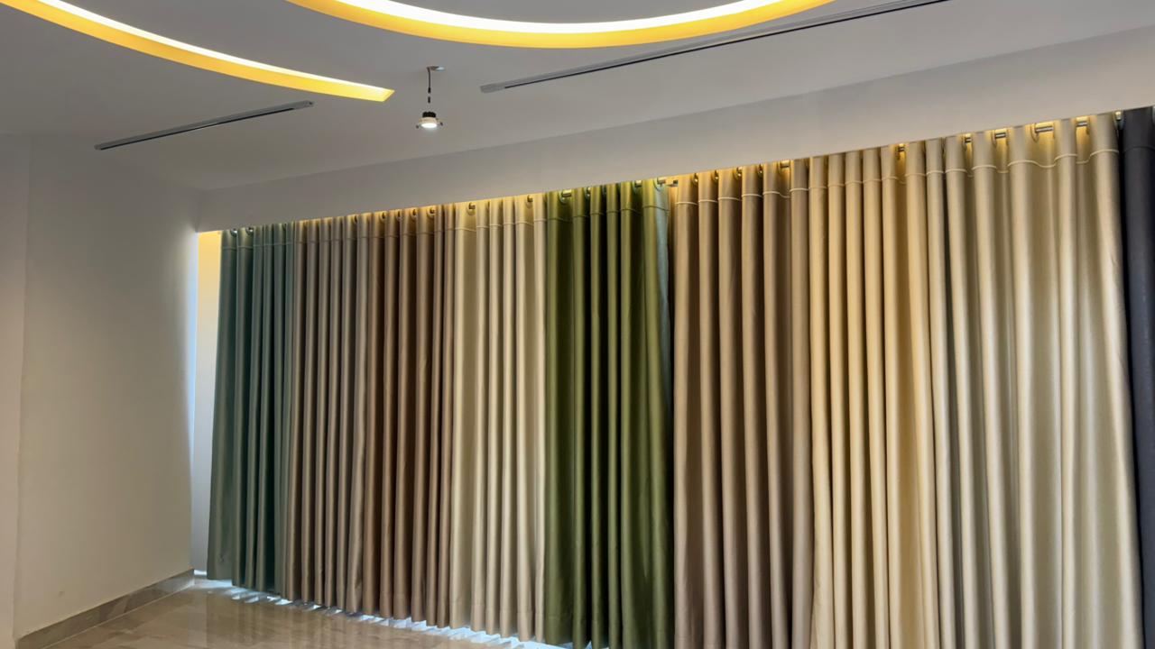 Curtivelle showroom media wall with sheer and blackout curtain displays