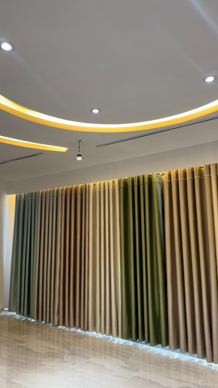 Curtivelle showroom media wall with sheer and blackout curtain displays