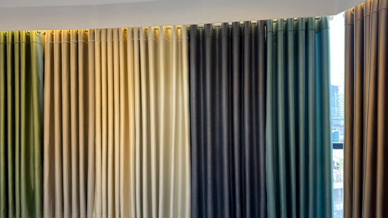 Wall-to-wall premium curtain fabric display in Curtivelle showroom