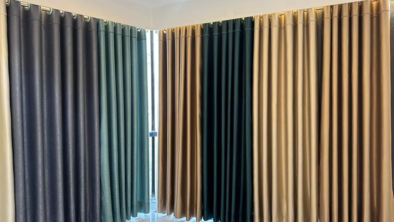Wall-to-wall premium curtain fabric display in Curtivelle showroom
