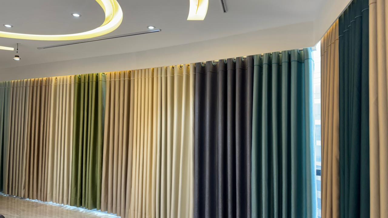 Wall-to-wall premium curtain fabric display in Curtivelle showroom